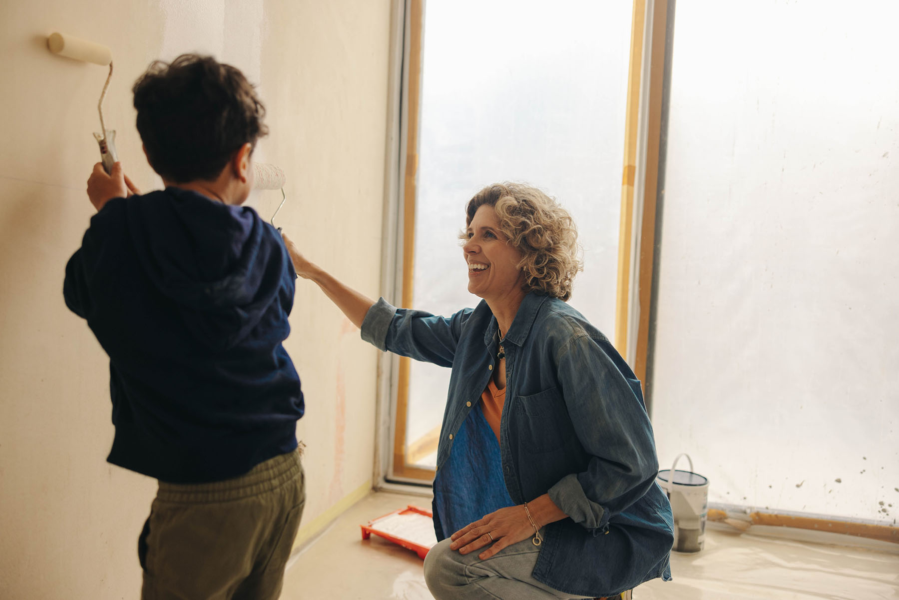 Mother and child painting together symbolizing life transitions and goal-oriented financial planning for families